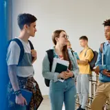 high school students talking in a school environment