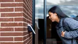 An image of a person using a biometric system to get into a building