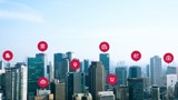 Image of city skyline with red icons above buildings