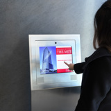 Image of a lady with a finger on a touchscreen video intercom