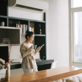 Woman looking at a phone and having a coffee