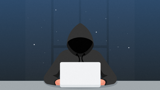 Hooded person at laptop
