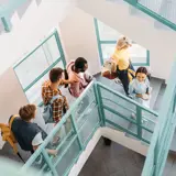 students walking down stairs at a school