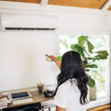 Woman turning on an aircon